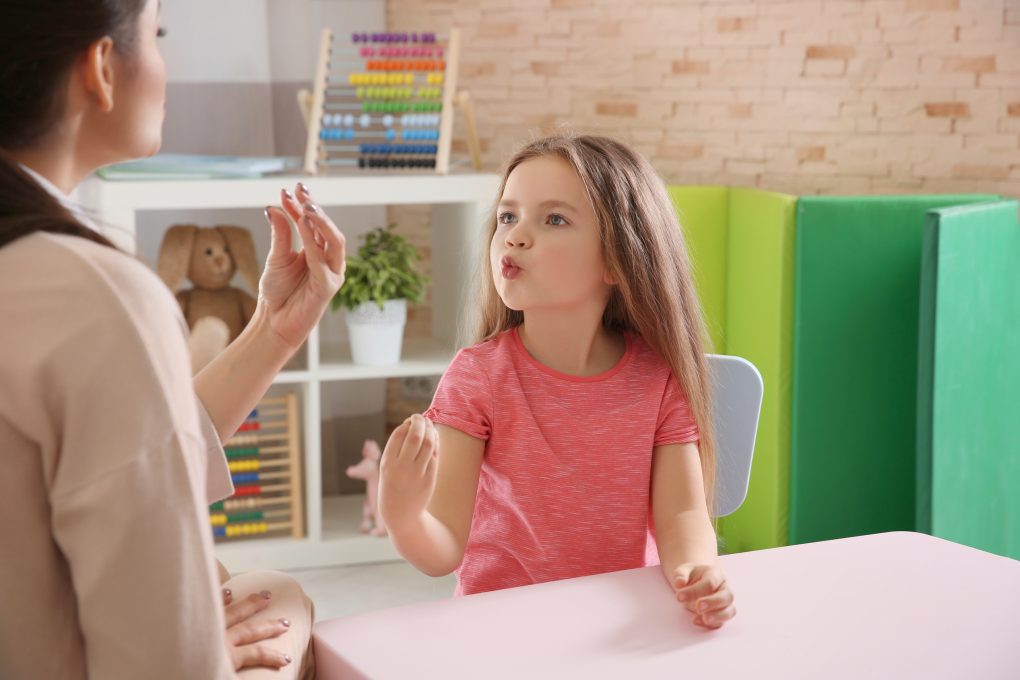 Young woman teacher and little girl on private lesson