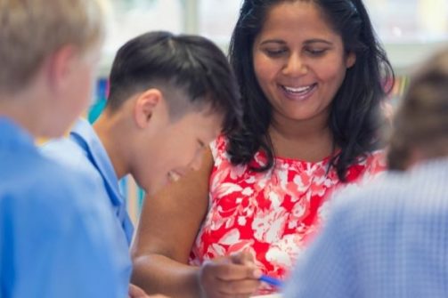 Young boy and his teacher smiling